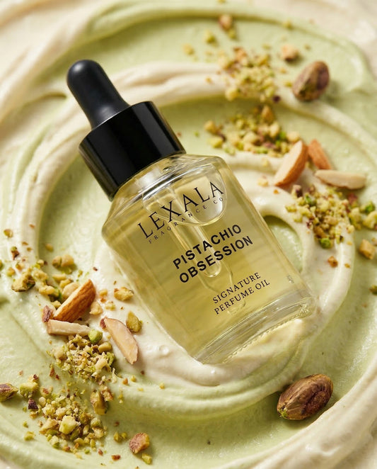 Lexala Pistachio Obsession perfume oil bottle on a green and white background with pistachios.